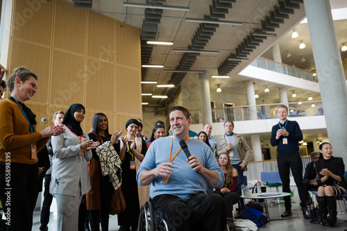 Speaker in wheelchair talking to audience