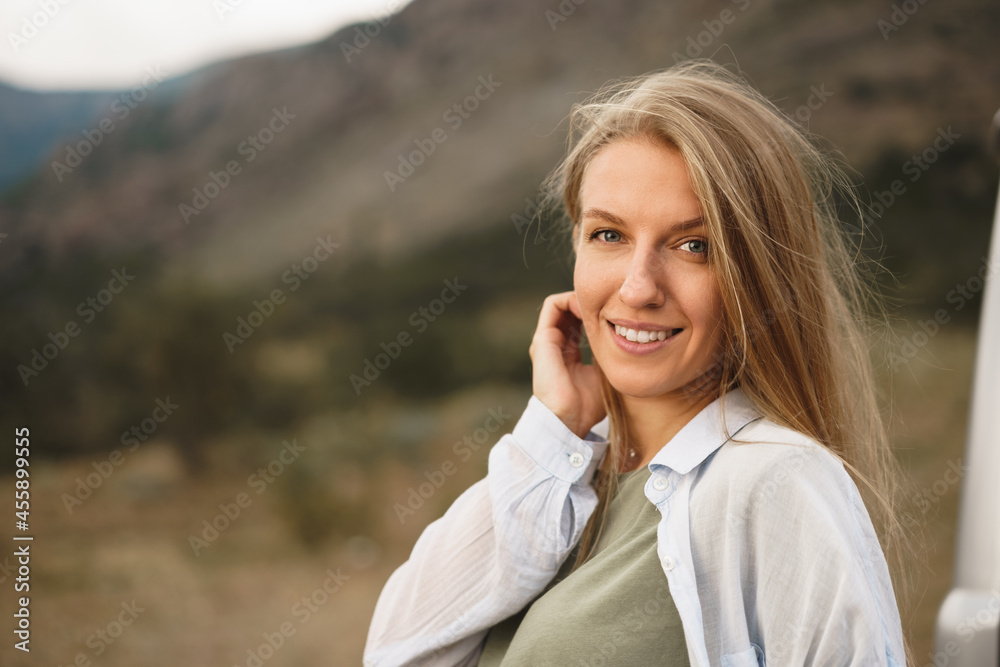 Portrait of happy young caucasian girl posing near off-road car Portrait of happy young caucasian girl posing near off-road car