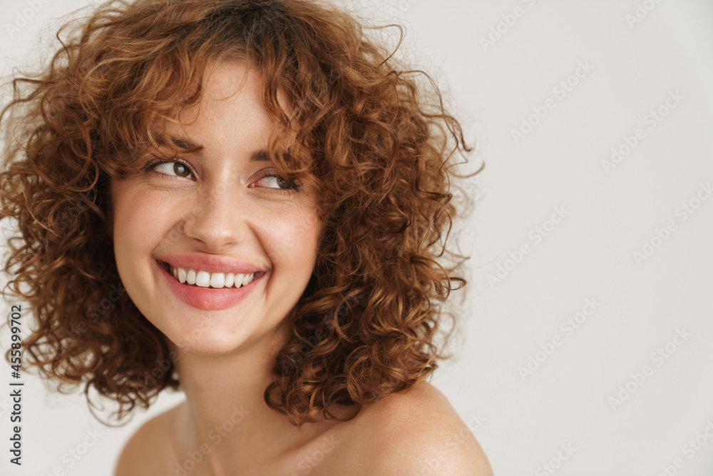 Half-naked ginger woman laughing and looking aside Half-naked ginger woman laughing and looking aside