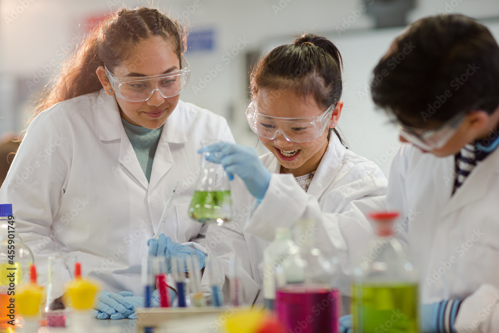 Students watching chemical reaction, conducting scientific experiment in laboratory classroom Students watching chemical reaction, conducting scientific experiment in laboratory classroom