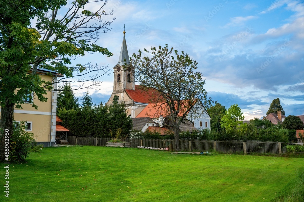 Building, old church, tree and meadow in garden in small village Hurky.