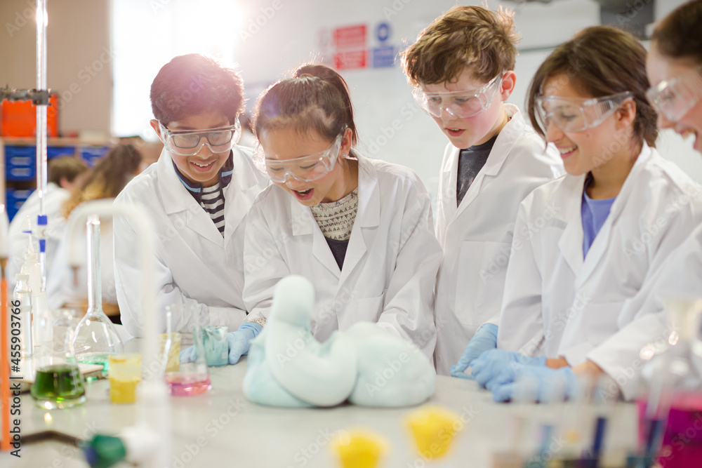 Surprised students conducting exploding foam scientific experiment in classroom laboratory Surprised students conducting exploding foam scientific experiment in classroom laboratory