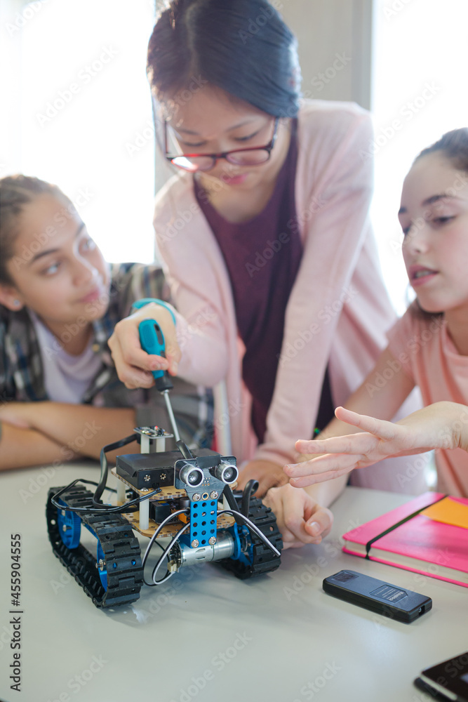 Students playing with robot in classroom Students playing with robot in classroom