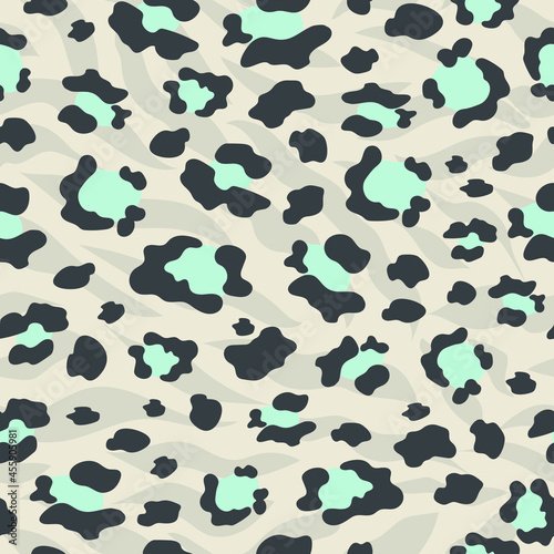 The leopard is trendy. Seamless pattern with wild animal blue and black spots for modern fabrics, textiles, throw pillows, bedding. Gray background. Vector.