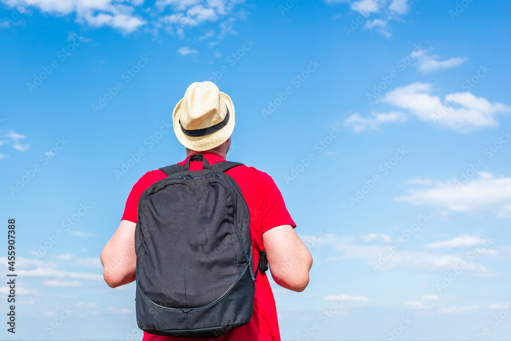 Young man admiring beautiful view of the forest landscape rear view.Young man standing alone summer day outdoors. Young man admiring beautiful view of the forest landscape rear view.Young man standing alone summer day outdoors.