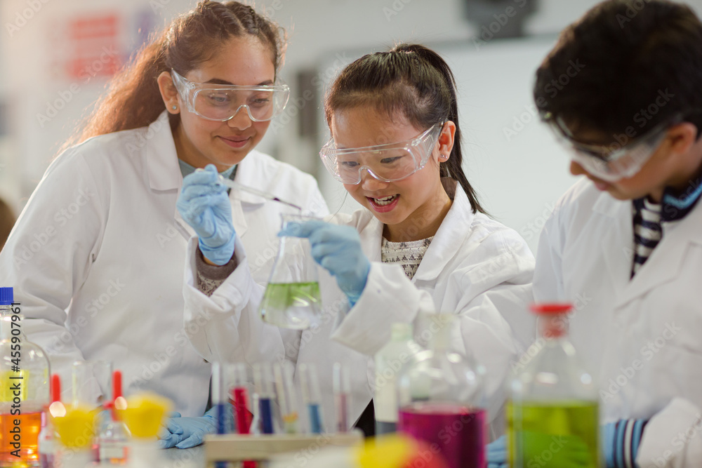 Students watching chemical reaction, conducting scientific experiment in laboratory classroom Students watching chemical reaction, conducting scientific experiment in laboratory classroom