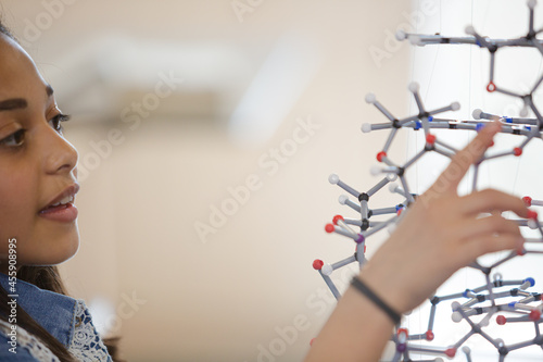 Curious girl student examining molecular structure