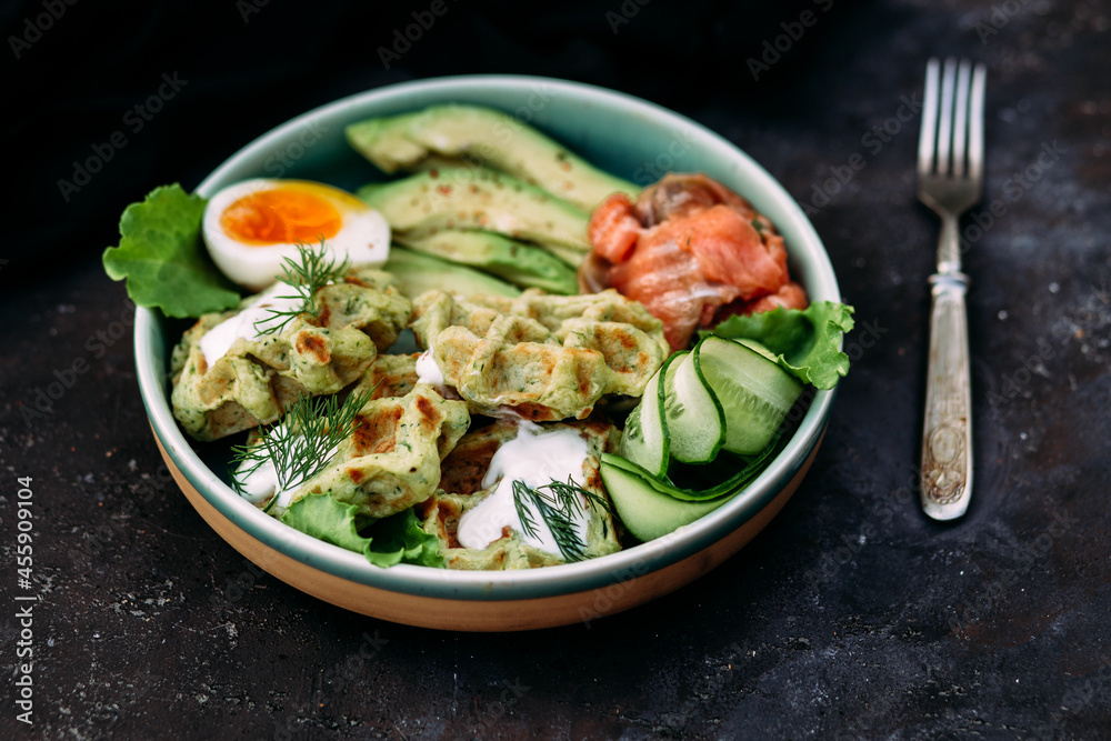 Belgian waffles with salmon, avocado and egg in a plate Belgian waffles with salmon, avocado and egg in a plate
