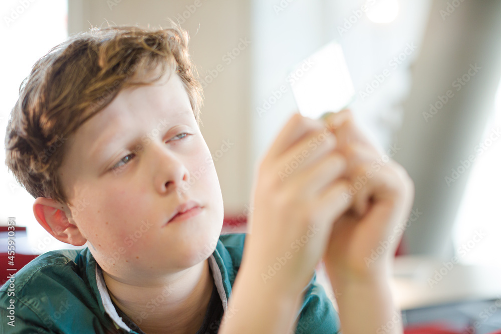 Boy student examining model in laboratory classroom Boy student examining model in laboratory classroom