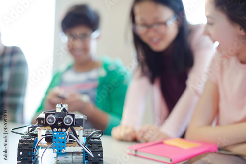 Students playing with robot in classroom