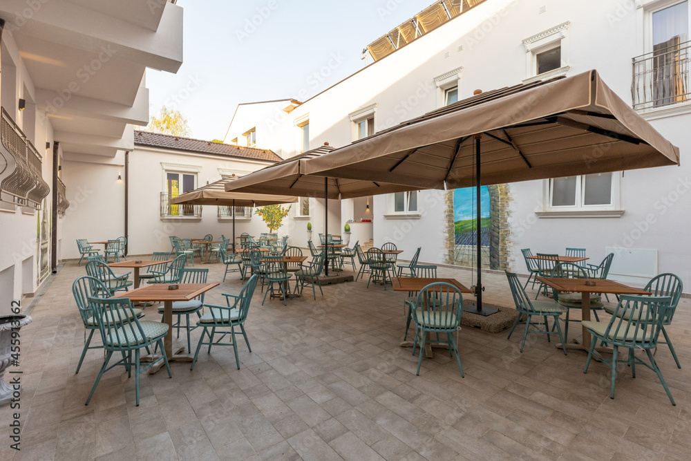 Empty terrace hotel restaurant with sun shades
