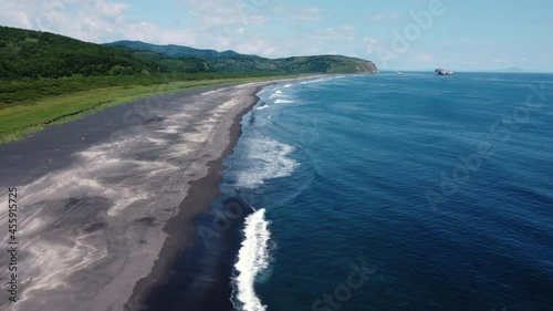 Landscape aerial view of empty Khalaktyrsky beach on sunny day. Kamchatka peninsula wild nature. Pacific ocean coast scenic drone footage.