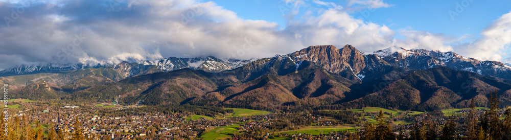 A beautiful panorama of the entire range of the Tatra Mountains. View of the giewont. Zakopane in the valley. The view at sunsets. Poland - obrazy, fototapety, plakaty 
