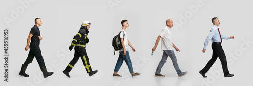 Line of different profile people walking isolated on white background. Professions of firefigter, lifeguard, student, painter and businessman. Collage photo