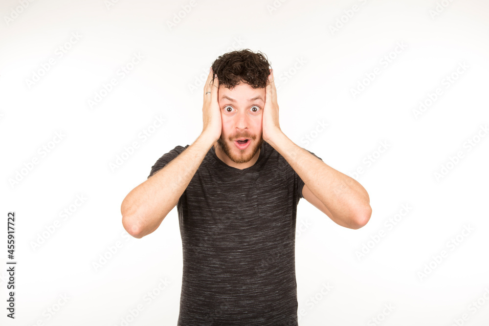 portrait isolated caucasian young man with surprised expression with hand on face portrait isolated caucasian young man with surprised expression with hand on face