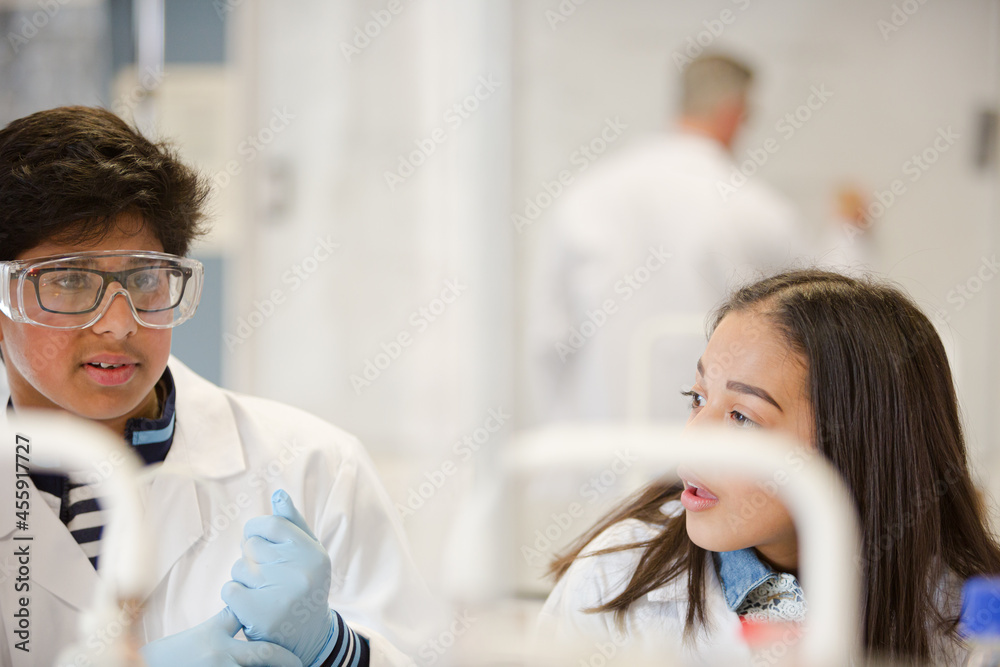Students conducting scientific experiment in laboratory classroom Students conducting scientific experiment in laboratory classroom