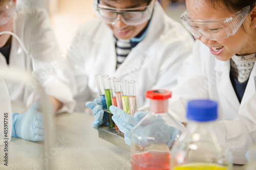 Students conducting scientific experiment in laboratory classroom