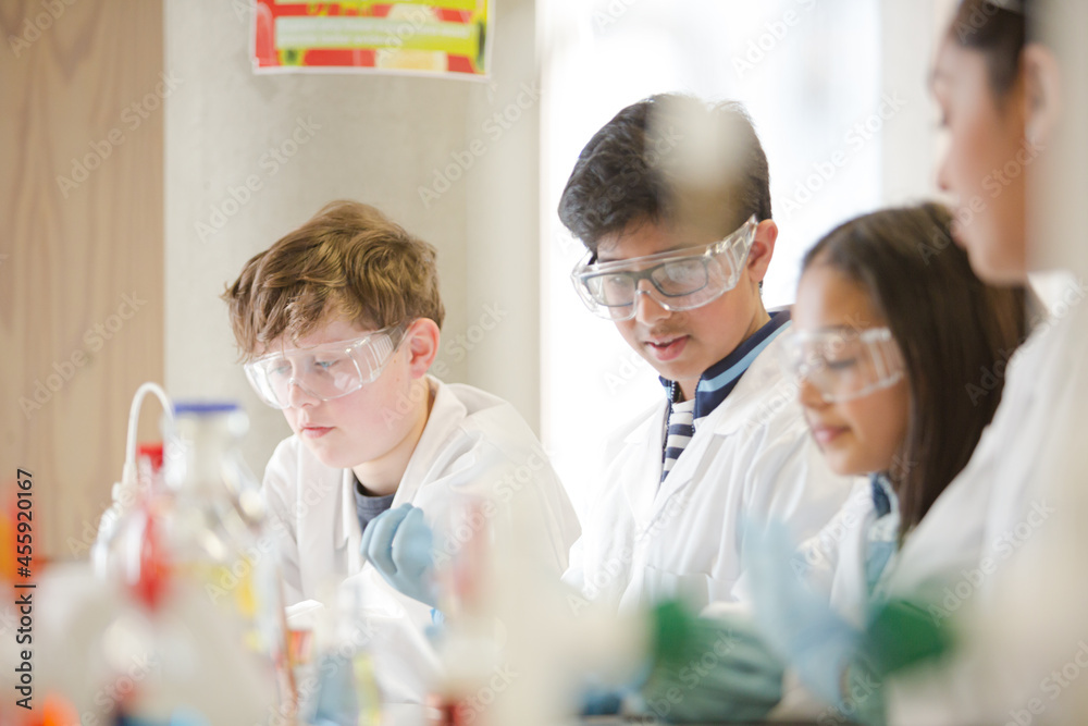 Students conducting scientific experiment in laboratory classroom