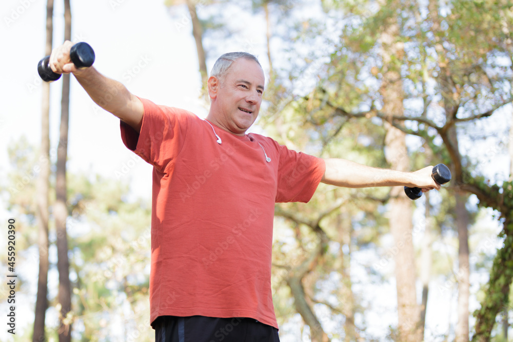 portrait of man training with dumbbells portrait of man training with dumbbells