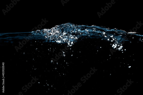 Water Surface with Ripple and Bubbles Float Up on Black Background. 
