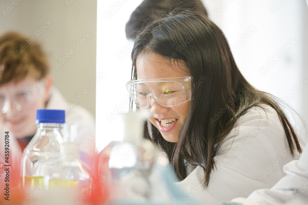 Students conducting scientific experiment in laboratory classroom Students conducting scientific experiment in laboratory classroom