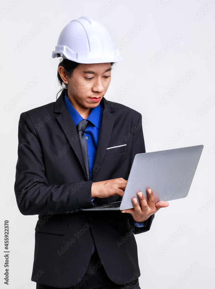 Asian professional successful male foreman industrial engineer in black formal suit and safety helmet standing on white background Asian professional successful male foreman industrial engineer in black formal suit and safety helmet standing on white background