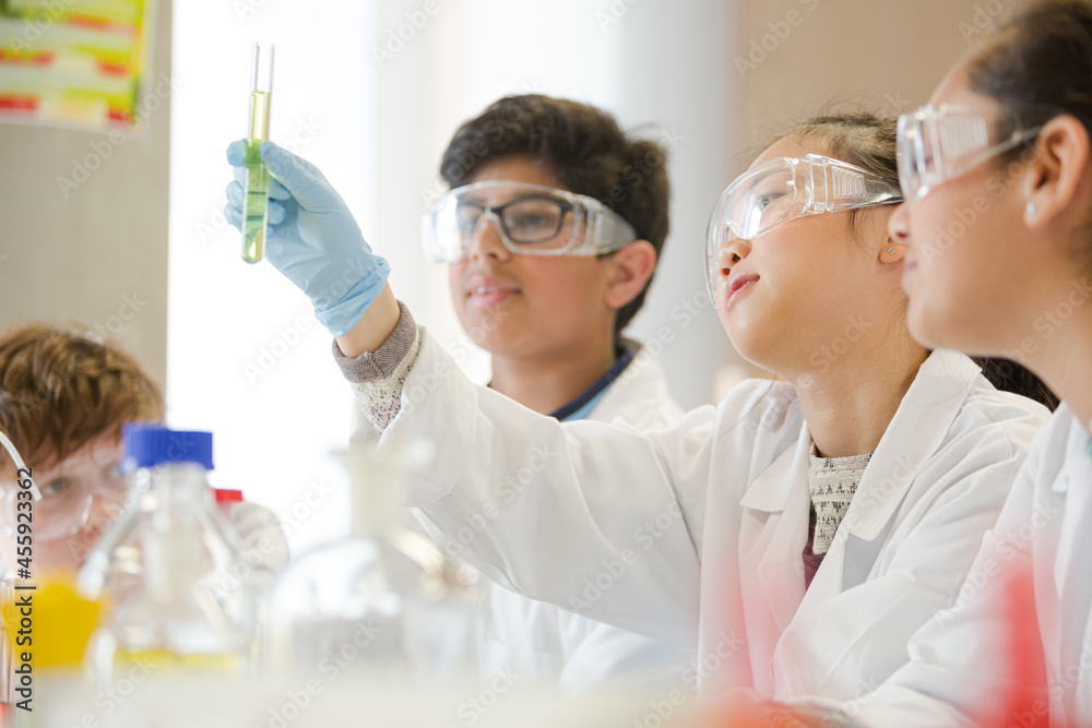 Students conducting scientific experiment in laboratory classroom Students conducting scientific experiment in laboratory classroom
