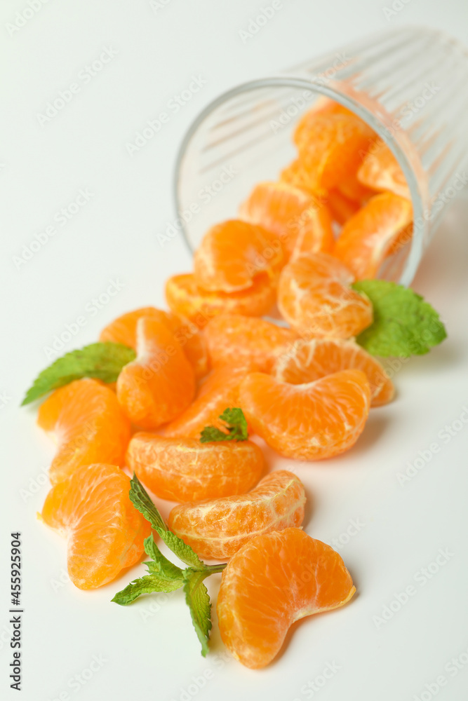 Concept of making mandarin juice with glass with mandarins on white background Concept of making mandarin juice with glass with mandarins on white background