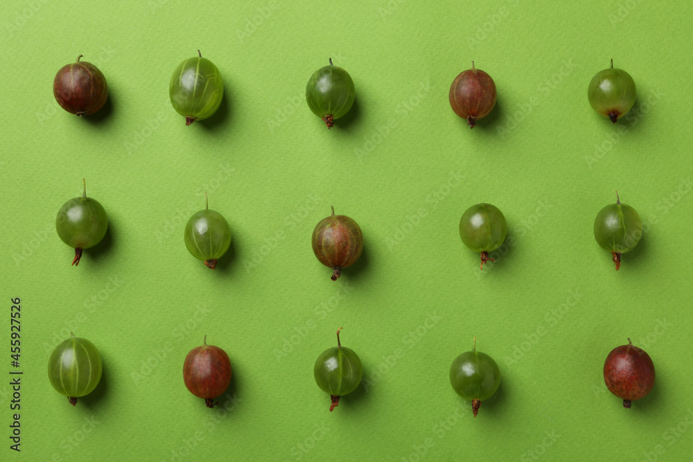 Flat lay with gooseberry on green background