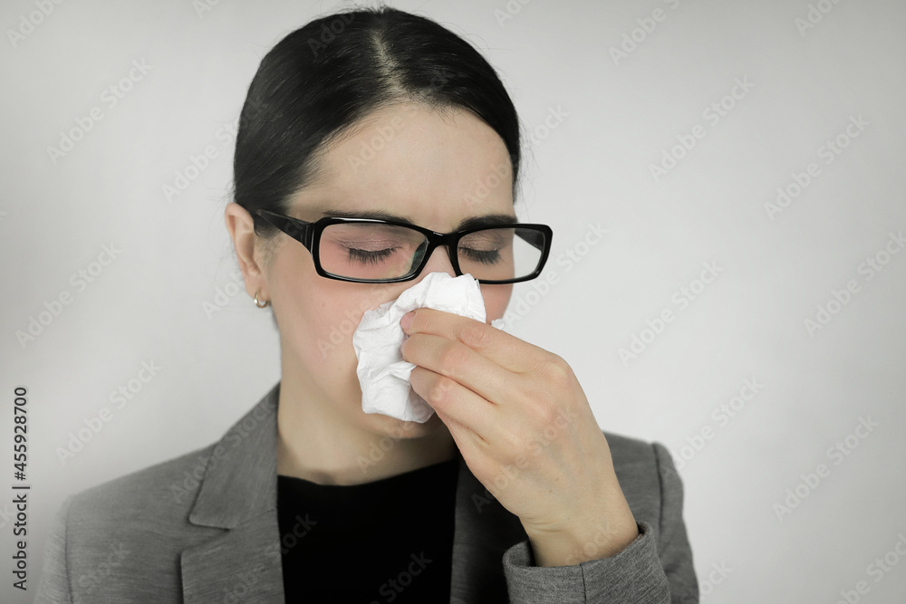 Young woman wearing glasses with flu symptoms Young woman wearing glasses with flu symptoms