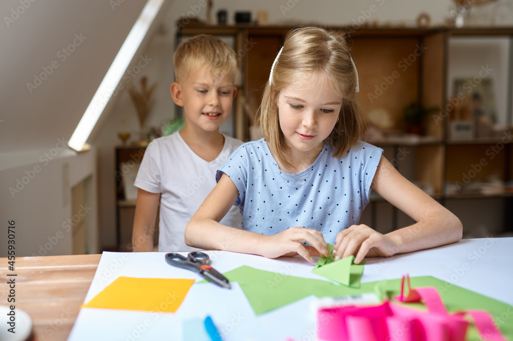 Boy and girl glue colored paper, art school Boy and girl glue colored paper, art school