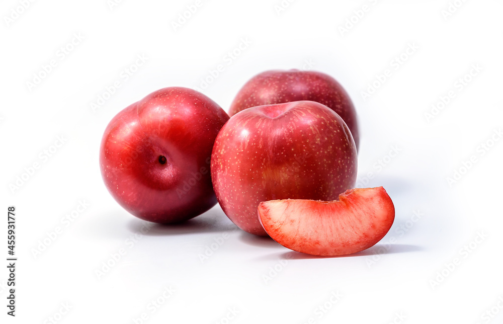 Raw Organic Red Plums on white background, fresh shiny fruits. Farm fresh organic red plums produce on white background Raw Organic Red Plums on white background, fresh shiny fruits. Farm fresh organic red plums produce on white background