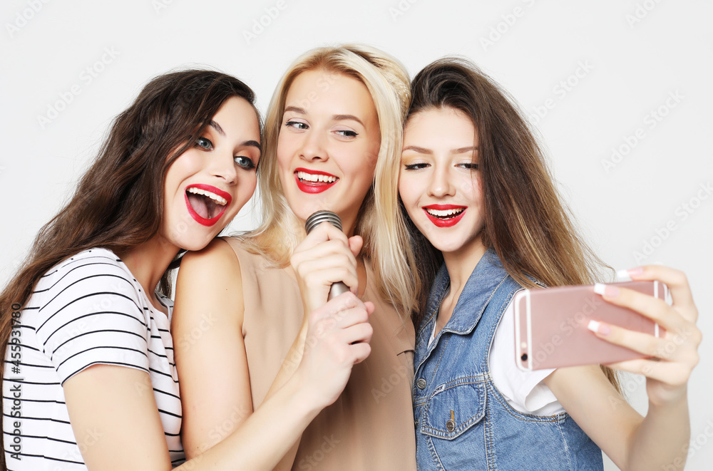 beauty girls with a microphone singing and having fun together beauty girls with a microphone singing and having fun together