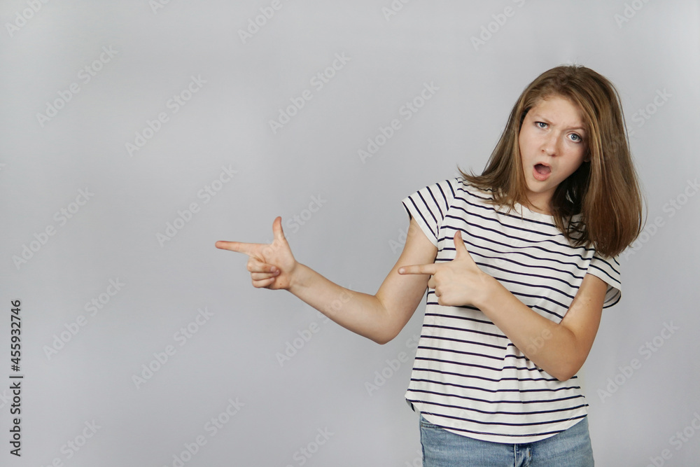 teenage girl points with two fingers to the side teenage girl points with two fingers to the side