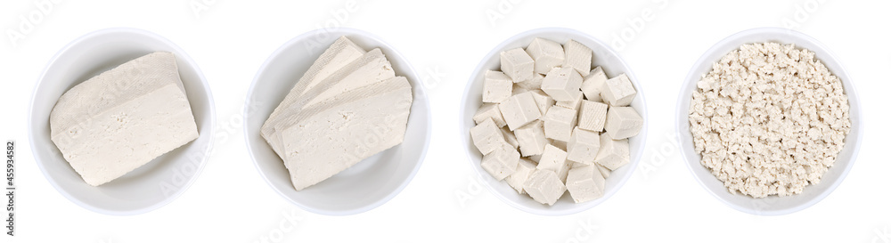 Processed white tofu, in white bowls. Single block, three slices,  cubes, and crumbled tofu. Bean curd, made of coagulated soy milk, a component of Asian cuisine and a meat substitute. Close-up. Photo - obrazy, fototapety, plakaty 