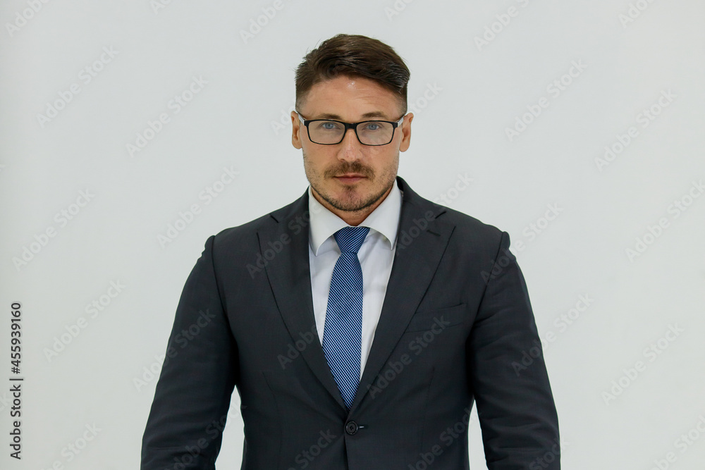 Isolated portrait studio shot of Caucasian masculine handsome smart confident professional successful businessman in formal black suit optical eyeglasses standing look at camera on white background Isolated portrait studio shot of Caucasian masculine handsome smart confident professional successful businessman in formal black suit optical eyeglasses standing look at camera on white background