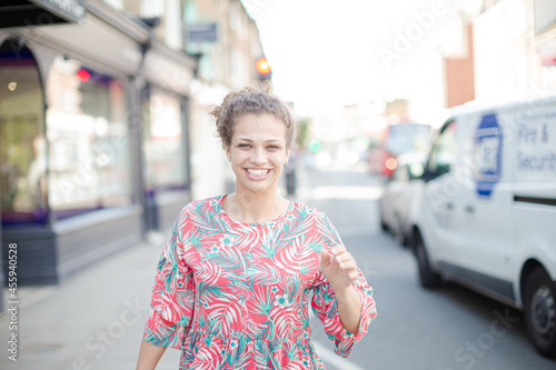Portrait smiling young woman on urban street © KOTO