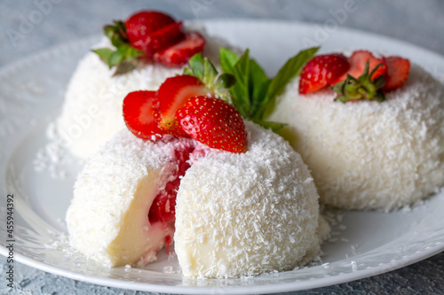 Delicious milk dessert; cup dessert with coconut and strawberry (Turkish name; fincan tatlisi photo