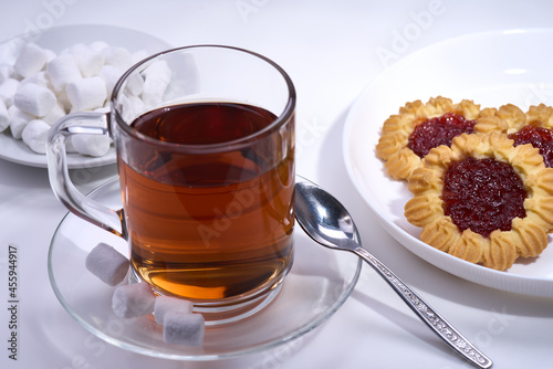 cup of tea and some cookies on white background selective focus