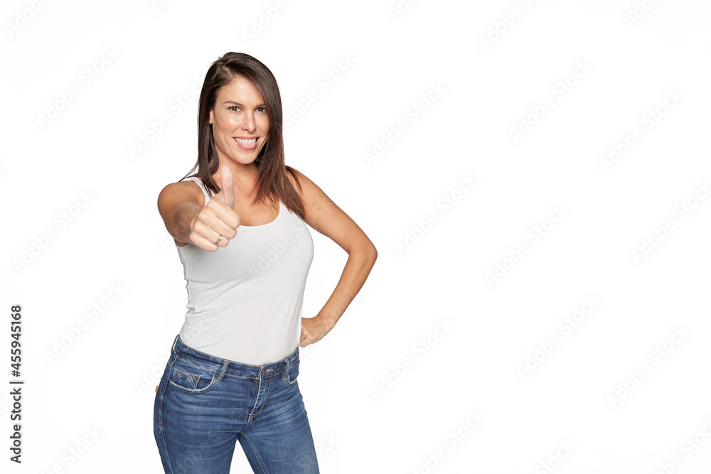 Beautiful brunette haired woman in jeans and white tank top on white background isolated Beautiful brunette haired woman in jeans and white tank top on white background isolated