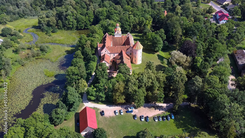 Edole Castle in Latvia, Courland (Kurzeme), Western Latvia. History, Architecture, Travel Destinations, National Landmark. Aerial View of Edole Medieval Castle Build in Neogothic Style Summer Day photo