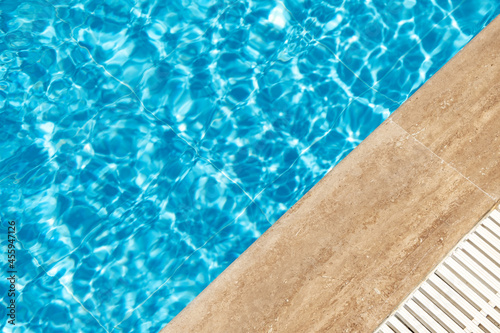 Border of swimming pool and blue ripped turquoise water. Summer vacation concept. Banner with copy space © lizaelesina