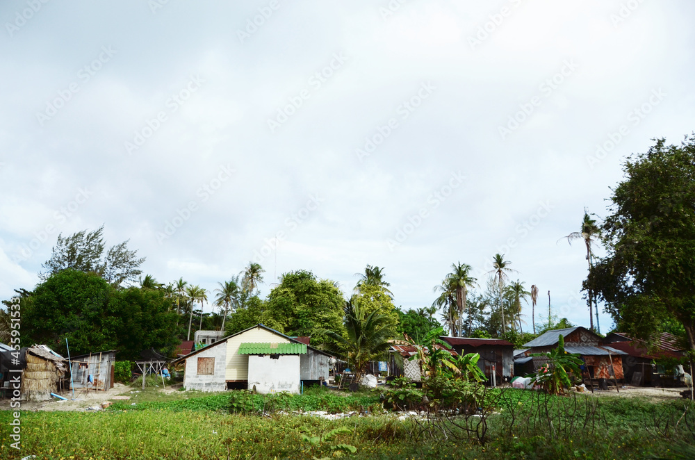 THAILAND, BANGKOK: Scenic landscape view of isolated Thai island with palms and traditional houses THAILAND, BANGKOK: Scenic landscape view of isolated Thai island with palms and traditional houses