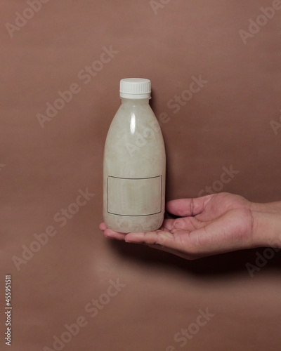 Kopyor drink in a bottle. This fresh drink is made from coconut that has a genetic disorder, so the flesh is soft and does not stick to the coconut shell. Suitable for thirst quencher during the day. photo