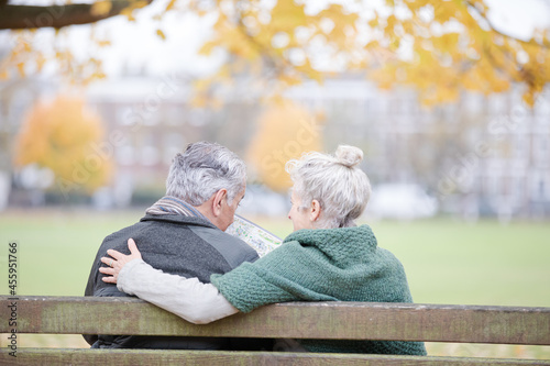 Wallpaper Mural Carefree, affectionate senior couple hugging on bench in autumn park Torontodigital.ca