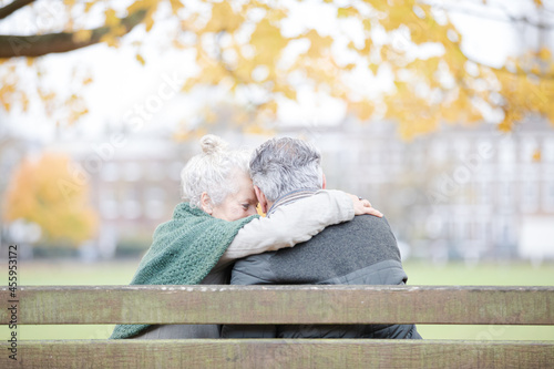 Wallpaper Mural Carefree, affectionate senior couple hugging on bench in autumn park Torontodigital.ca