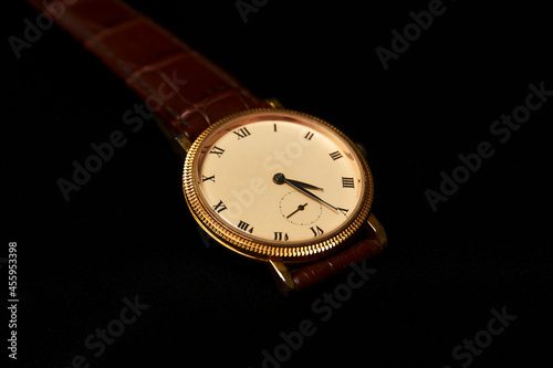 Men's wrist watch on dark background, close-up