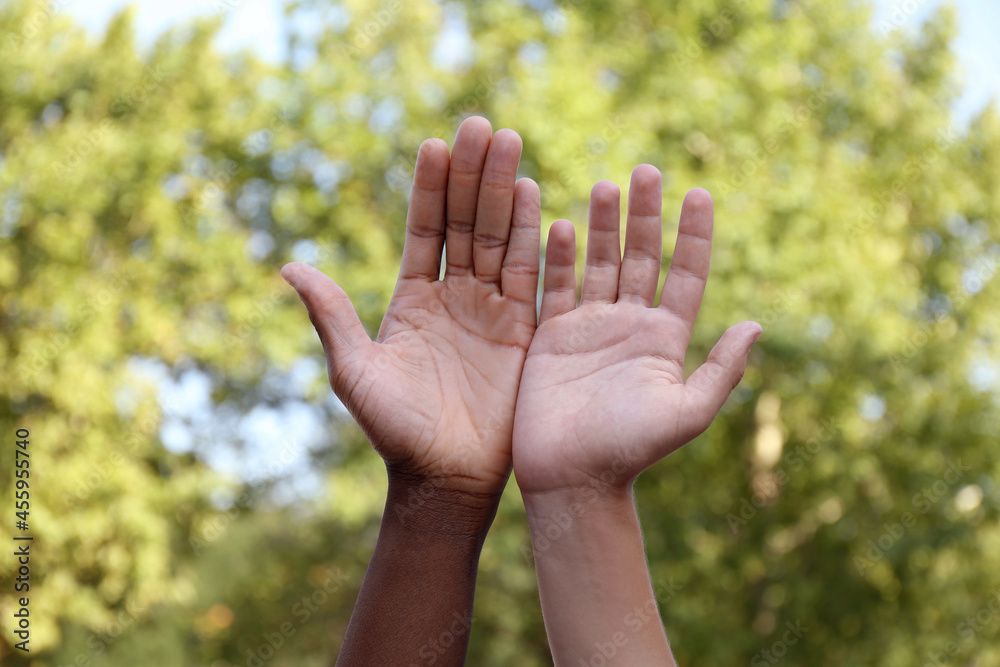 Closeup view of men showing hands outdoors Closeup view of men showing hands outdoors