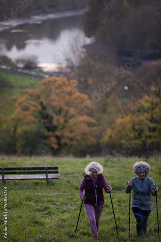 Portrait smiling, happy active senior women friends with walking sticks