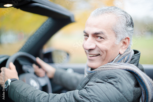 Smiling, affectionate senior man in car © KOTO
